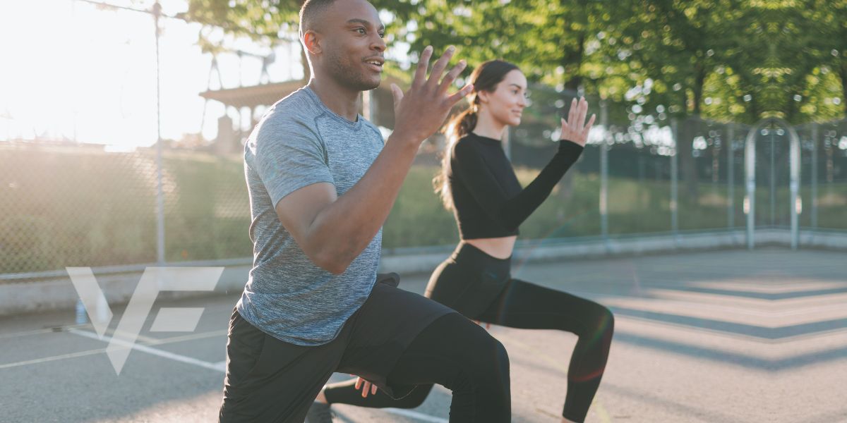 two people doing lunges together at the park